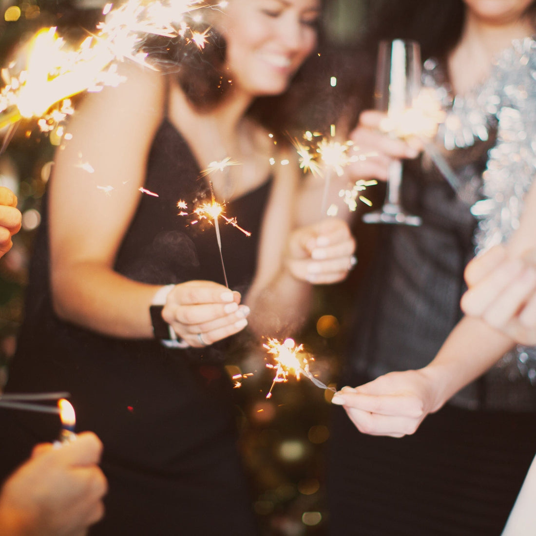 photo of friends with sparklers celebrating new years eve